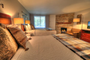 Cozy River Edge Inn guest room with fireplace during winter season