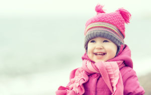 happy girl in pink hat and scarf