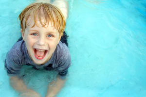 super happy kid playing in pool